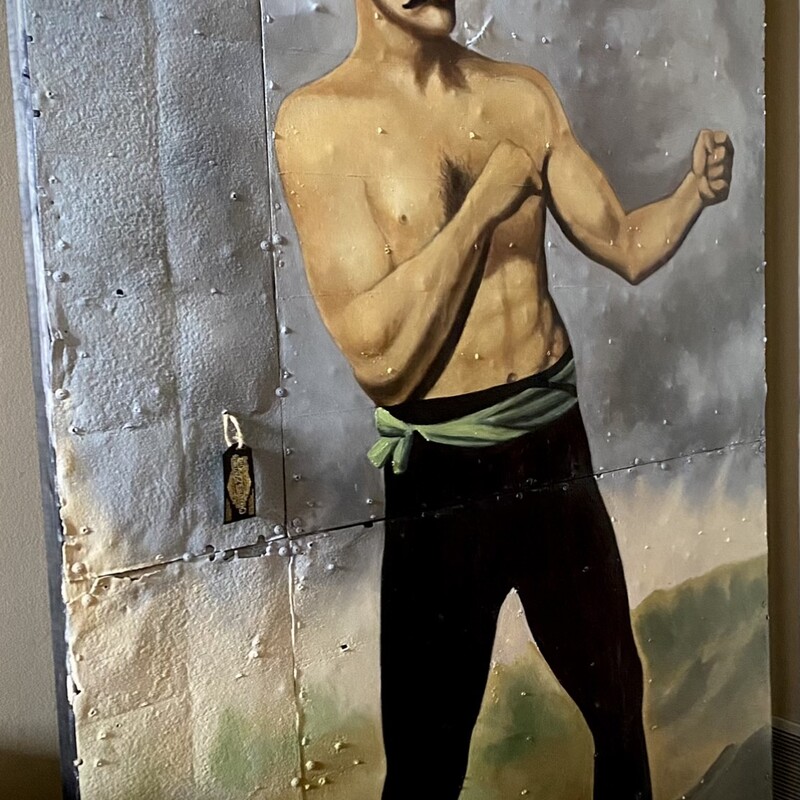 Boxer
Dimensions:  49.2W x 1.5D x 78.75H
This vintage-inspired boxer art features oil painted  on reclaimed tin roofing.  The reclaimed tin adds to the vintage feel with a distinctive rough exterior and common voids that this surface naturally presents. This painting is not on standard canvas.  Please look closely as this is shown in photos