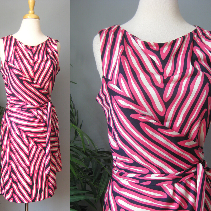 DVF Striped Silk Jersey, Pink, Size: Large
Sophisticated versatile and flattering dress from Diane von Furstenberg.
Silk jersey in a black white and pink abstract stripe pattern
It's a faux wrap dress, you pull it on over your head and then tie the attached sashes at the side of your waist.
Unlined
no closures

It's marked size 10.  There is a good amout of stretch to the fabric and you will want it to fit to the curves.
please check the actual garment measurements below

Flat measurements, please double where appropriate:
Armpit to Armpit: 19
Waist: 15.75
Hip: 20
Length: aprox 37.5

Excellent condition!

Thanks for looking.
#60281
