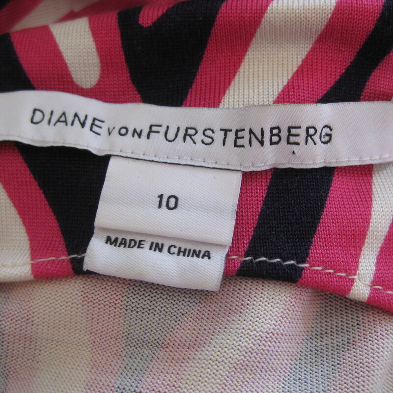 DVF Striped Silk Jersey, Pink, Size: Large<br />
Sophisticated versatile and flattering dress from Diane von Furstenberg.<br />
Silk jersey in a black white and pink abstract stripe pattern<br />
It's a faux wrap dress, you pull it on over your head and then tie the attached sashes at the side of your waist.<br />
Unlined<br />
no closures<br />
<br />
It's marked size 10.  There is a good amout of stretch to the fabric and you will want it to fit to the curves.<br />
please check the actual garment measurements below<br />
<br />
Flat measurements, please double where appropriate:<br />
Armpit to Armpit: 19<br />
Waist: 15.75<br />
Hip: 20<br />
Length: aprox 37.5<br />
<br />
Excellent condition!<br />
<br />
Thanks for looking.<br />
#60281