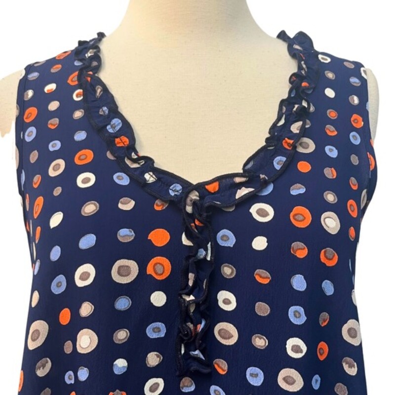 Loco Lindo DotsTunic Top<br />
Sleeveless<br />
Ruffled Neckline<br />
100% Rayon<br />
Navy, Coral, Blue, Beige, Mocha, and White<br />
Size: Small