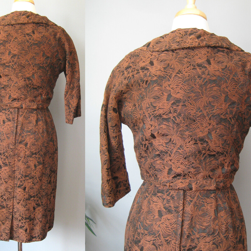 Gorgeous brocade two piece ensembly from the 1950s by Leslie Fay.
It's black and brown with a textured floral/foliage pattern.
The fabric is substantial
There is a fitted dress with little capped sleeves and a cropped bolero jacket with round almost portrait collar, three quarter sleeves and covered buttons.

Details & Measurments:

Jacket: the body of the jacket is linedin black fabric, but not the sleeves.
Shoulder to Shoulder: 14.75 (this is narrow)
Armpit to armpit: 21
Length: 15

Dress: it has a center back metal zipper
armpit to armpit: 18
waist: 14
hip: 19.5
length:38

Excellent condition!
Thank you for Looking
#57302.