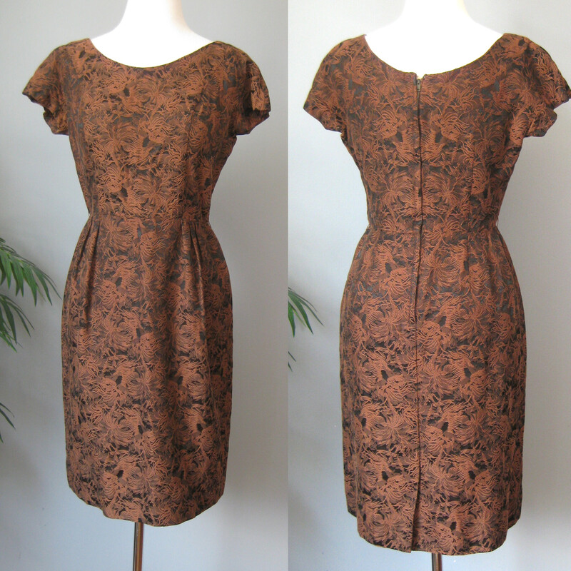 Gorgeous brocade two piece ensembly from the 1950s by Leslie Fay.<br />
It's black and brown with a textured floral/foliage pattern.<br />
The fabric is substantial<br />
There is a fitted dress with little capped sleeves and a cropped bolero jacket with round almost portrait collar, three quarter sleeves and covered buttons.<br />
<br />
Details & Measurments:<br />
<br />
Jacket: the body of the jacket is linedin black fabric, but not the sleeves.<br />
Shoulder to Shoulder: 14.75 (this is narrow)<br />
Armpit to armpit: 21<br />
Length: 15<br />
<br />
Dress: it has a center back metal zipper<br />
armpit to armpit: 18<br />
waist: 14<br />
hip: 19.5<br />
length:38<br />
<br />
Excellent condition!<br />
Thank you for Looking<br />
#57302.