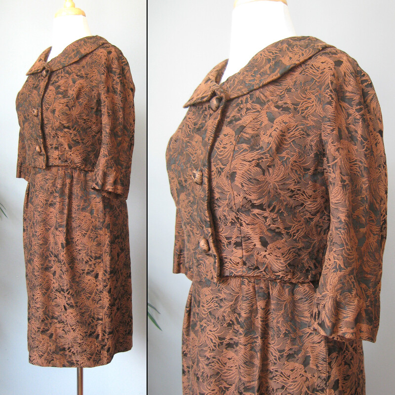 Gorgeous brocade two piece ensembly from the 1950s by Leslie Fay.<br />
It's black and brown with a textured floral/foliage pattern.<br />
The fabric is substantial<br />
There is a fitted dress with little capped sleeves and a cropped bolero jacket with round almost portrait collar, three quarter sleeves and covered buttons.<br />
<br />
Details & Measurments:<br />
<br />
Jacket: the body of the jacket is linedin black fabric, but not the sleeves.<br />
Shoulder to Shoulder: 14.75 (this is narrow)<br />
Armpit to armpit: 21<br />
Length: 15<br />
<br />
Dress: it has a center back metal zipper<br />
armpit to armpit: 18<br />
waist: 14<br />
hip: 19.5<br />
length:38<br />
<br />
Excellent condition!<br />
Thank you for Looking<br />
#57302.