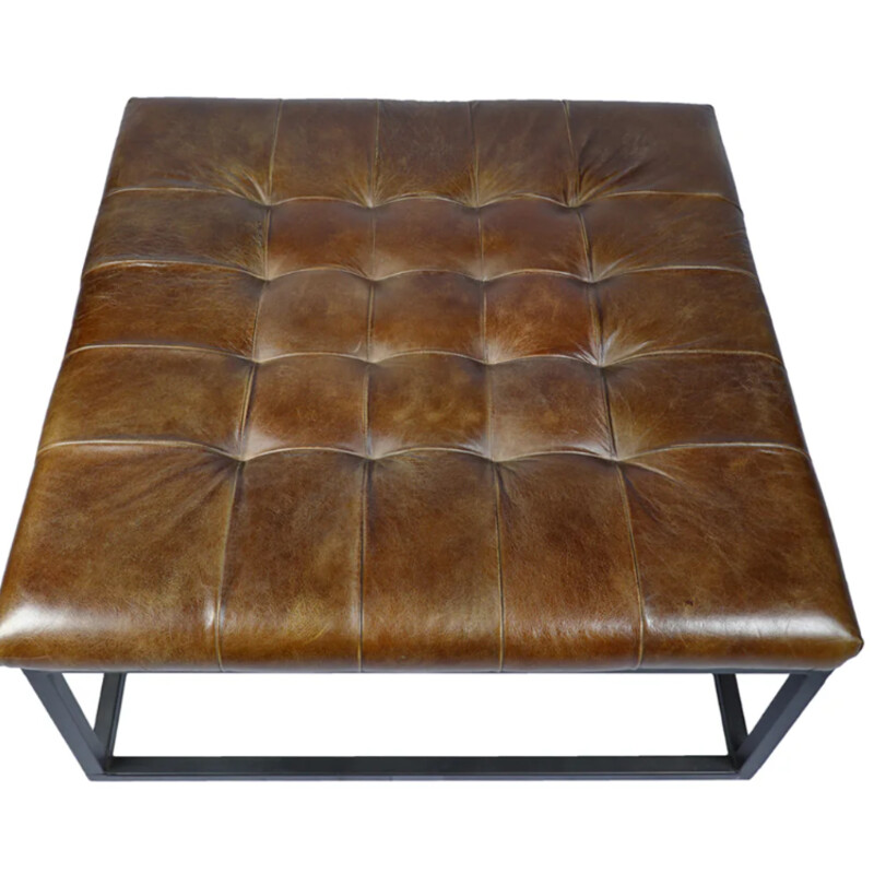 Leather Square Ottoman
Size: 33x33x17H
A modern take on a classic look, this stylish foot stool makes a luxurious addition to living or office spaces. Button-tufted cowhide leather is handcrafted on an understated iron frame.
NEW Retail $899
