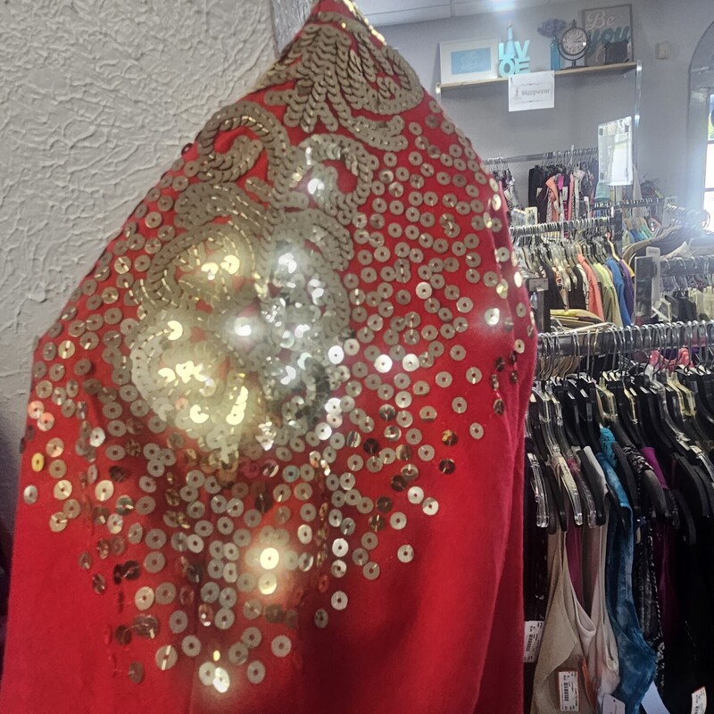 Half sleeve knit top in red with gold sequin shoulders for added sparkle and shine.  Great for the holidays.