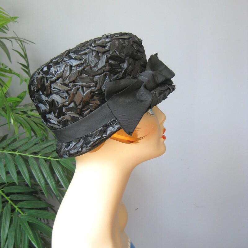 Cloche hats are naturally dramatic and coquettish.
This one is made of black cellophane straw.
There is a wide grosgrain ribbon encircling the crown finished with a large bow.


Excellent condition!
Inner hat band measures 201/4

You want this hat to sit low on your head so if you don't already know, do wrap a tape measure around your head to see where the hat is going to sit on you and make sure you're happy with that.

Thanks for looking!
#62834