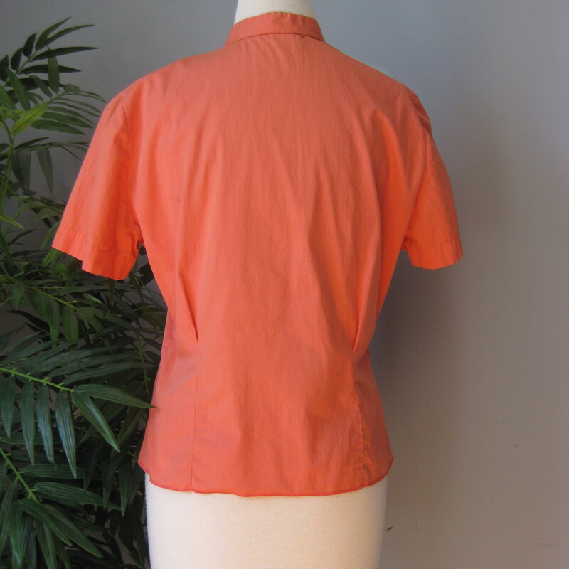 Super Cute coral blouse from the 50s with tiny white plastic buttons and pretty scalloped stitching at the upper chest.<br />
Made by Judy Bond it doesn't have any fabric tags but I am certaint that it's cotton.<br />
Short sleeves<br />
No stretch<br />
This blouse had two darts running from the hem up to the bust which have been let out.<br />
This was VERY common practice in the olden days as people took very good care of the their clothes and the clothes were frequently designed to allow for changes in age/size/pregancy.  No such thing as fast fashion in those days!<br />
Flat measurements:<br />
Shoulder to shoulder: 16<br />
Armpit to Armpit: 22<br />
Length: 22.5<br />
Waist: 18 - you could easily modify the fit on this blouse to be a little more form fittings by sewing up the darts mentioned above.<br />
<br />
Excellent condition!<br />
<br />
thanks for looking!<br />
#1604