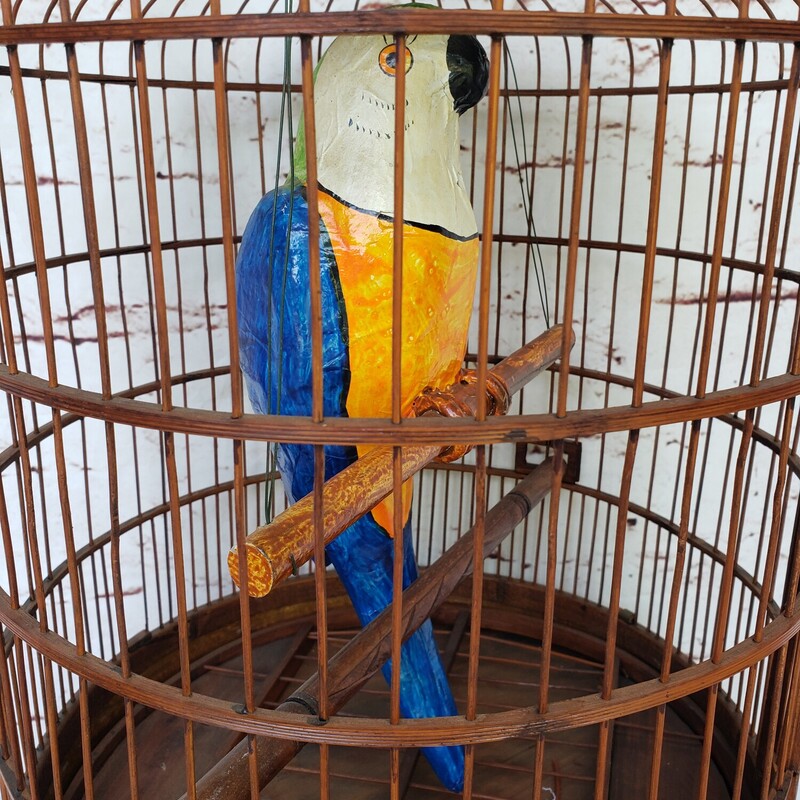Vintage Birdcage. Rattan cage with paper mache parrot. Size: 29in tall