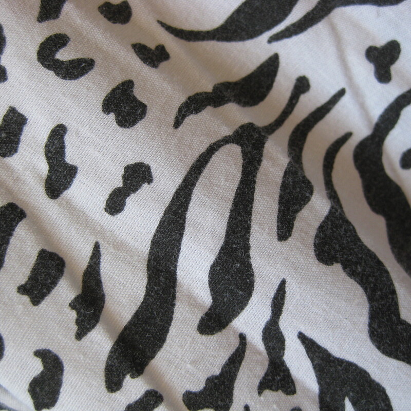 This is a pretty flowy skirt from the early 80s or maybe even the 70s<br />
It was handmade of black and white abstract animal print in cotton or possible rayon<br />
It has a waist band and a center back zipper and pants sliding hook and eye closure/<br />
unlined<br />
very full!<br />
Great condition.<br />
Cute though!<br />
Should fit a size small to medium<br />
Flat measurements:<br />
waist:  13.75<br />
hip: free<br />
length: 31.5<br />
<br />
<br />
Thanks for looking!<br />
#57930