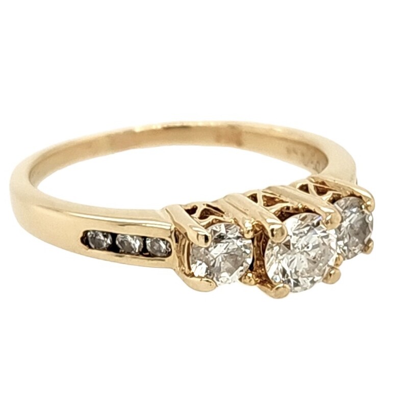 Past Present Future Style Anniversary Band<br />
3 Round Diamonds in Center and 6 Accent Diamonds Channel Set in Band<br />
1/2 Carat Total Weight<br />
14Kt Yellow Gold