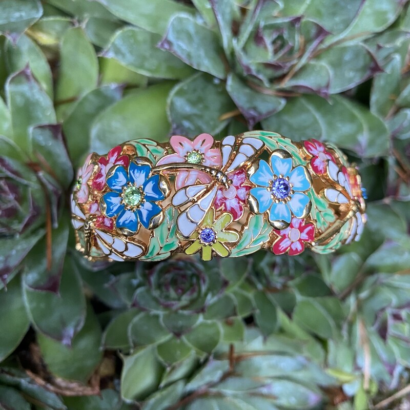 Joan Rivers Enamel Colorful Flowers Dragonfly Hinged Bracelet Gold Tone Rare HTF<br />
Goldtone oval shape; cutout floral design; epoxy enamel, round faceted crystals in shades of blue, lilac, and green<br />
Snap hinge<br />
Signed Joan Rivers<br />
Fits an average-sized wrist- Interior circumference measures approximately 7L<br />
Measures approximately 7/8W