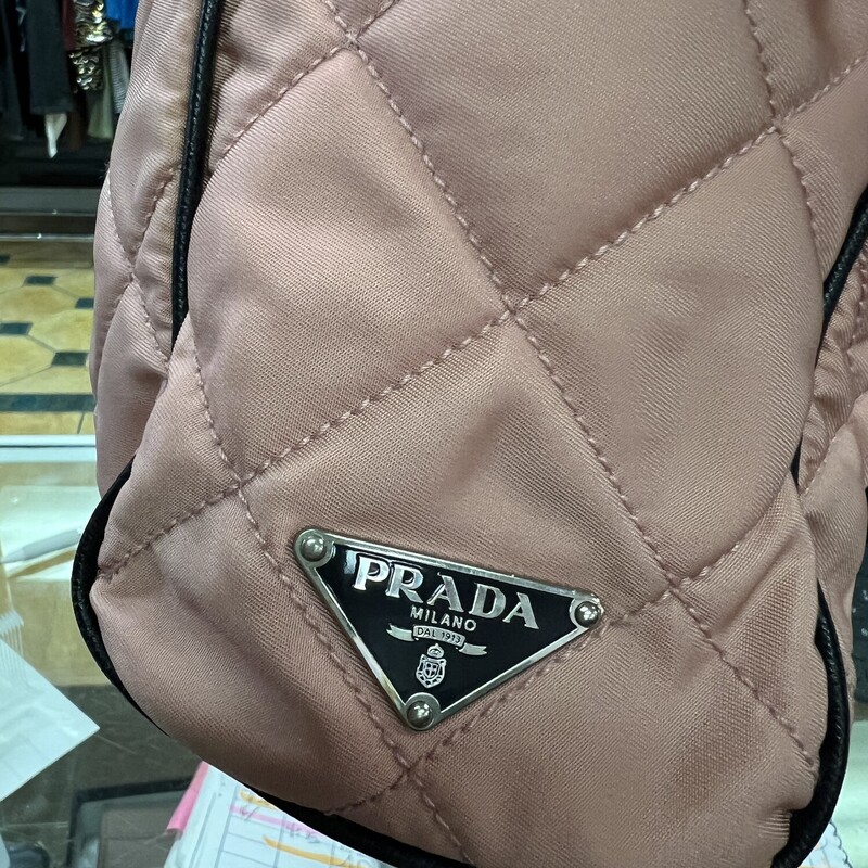PRADA<br />
PRE-OWNED PRADA PINK LEATHER NYLON CHAIN ZIP TOTE BAG<br />
This is your opportunity to own this chic and stylish Prada Pink Quilted Nylon Shopping Tote Bag. This spacious tote has the capability to hold all your daily essentials. It is made of quilted nylon with leather straps entwined with silvertone chain links. Makes a perfect casual everyday bag!<br />
Prada Pink Leather Nylon Chain Zip Tote Bag with silver-tone hardware, saffiano leather trim, and includes two exterior side-end pockets, Dual leather and chain shoulder/hand straps, Interior includes one large zippered pocket, zip, open closure.<br />
 10\"W x 9\"H x 2.5\"D / 25.4 x 22.8 x 6.35 cm<br />
This bag is in excellent condition.  Interior is spotless and the exterior shows very little signs of wear.