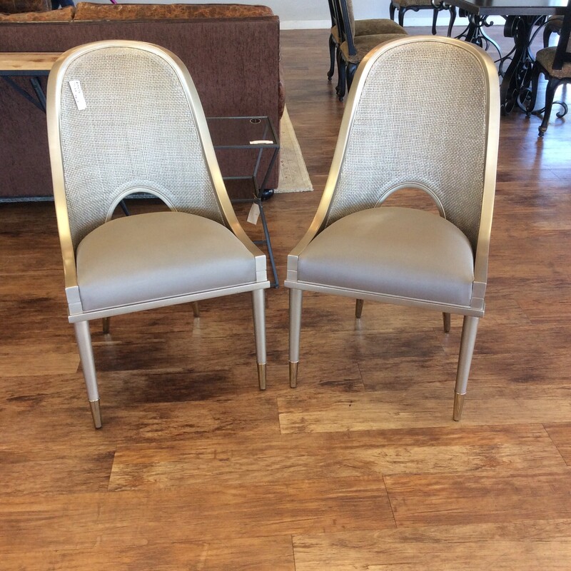 This pair of side chairs from Caracole have caned backs and are done in satin gold finish.