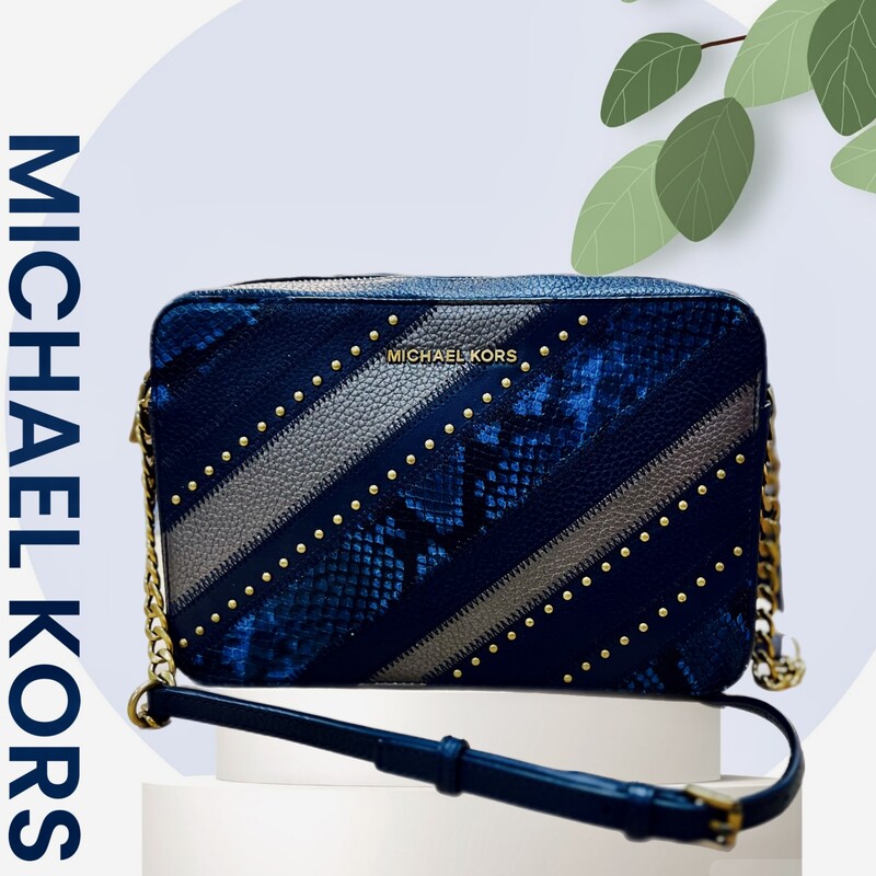Michael Kors Leather Navy Multi Snake Jet Set Crossbody
MSRP $ 228.00
Approx. 9.5\" (L) x 6.25\" (H) x 2.15\" (D)
Snake embossed with pebbled leather colorblocked stripes at front
Zip top closure
Antique-brass studs and hardware
Adjustable leather with chain-detail strap approx. 23\" drop
Interior features: Signature polyester fabric and leather lining
1 back wall padded tech pocket and 1 slip pocket on front wall