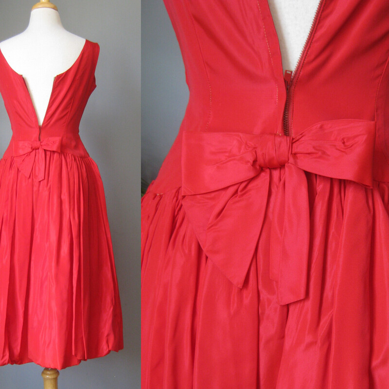 This pretty vintage semi formal dress was handmade.<br />
Fitted Sleeveless bodice with a modest scoop neckline<br />
Pretty oblong rhinestone pin at the center waist<br />
The skirt is very full with a bubble hem and supported by a stiff backing.<br />
The tafetta fabric also has a lot of body and no stretch<br />
Pretty bow in the back<br />
Metal zipper<br />
It's smaller than a modern size 4 and cut for a teenagers body, ie. narrow in the rib cage and across the back.  You can see it does not zip all the up on my size 4 mannequin.<br />
<br />
Here are the flat measurements, please double where appropriate:<br />
<br />
Armpit to armpit: 17<br />
Waist: 13<br />
Hip: up to 23<br />
Length: 43 from shoulder to hem.<br />
<br />
Excellent condition!<br />
<br />
<br />
Thanks for looking!<br />
#62652