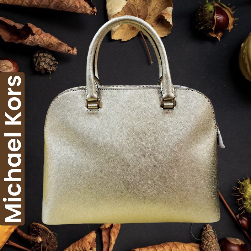 MICHAEL KORS
Cindy Saffiano Leather Large Dome Satchel Bag
Length: 12.5\" at bottom
- Height: 9.75\"
- Depth: 5\" at bottom
- Double roll Saffiano leather handles with 5\" drop.
- Comes with shoulder strap, can be used as a satchel or taken out and used as a handbag
In like new condtion.  crossbody strap still wrapped in paper and zipper pulls as well.
No marks or flaws identified.
Beautiful Gold Color.