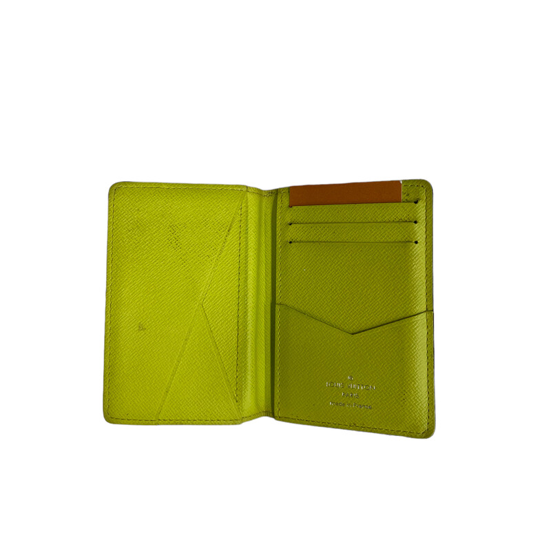 LOUIS VUITTON Monogram Taiga Pocket Organizer in Jaune. This trim card holder is made of the traditional monogram canvas in bright yellow and opens to a cross grain leather interior with patch pockets and card slots, with the luxury and style of Louis Vuitton!

Dimensions:
Base length: 3.00 in
Height: 4.50 in
Width: 0.75 in
 *Some Marks on the front
