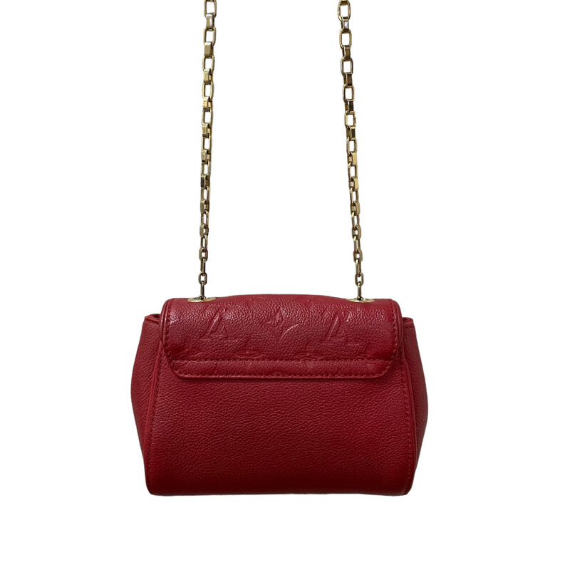 Louis Vuitton St Germain, Red, Size: BB
Louis Vuitton Crossbody Bag
From the 2016
Red Empreinte Leather
Brass Hardware
Chain-Link Shoulder Strap
Leather Trim Embellishment
Alcantara Lining & Single Interior Pocket
Push-Lock Closure at Front

Dimensions:
Height: 5.75
Width: 7
Depth: 2.75
Some minor wear on corners