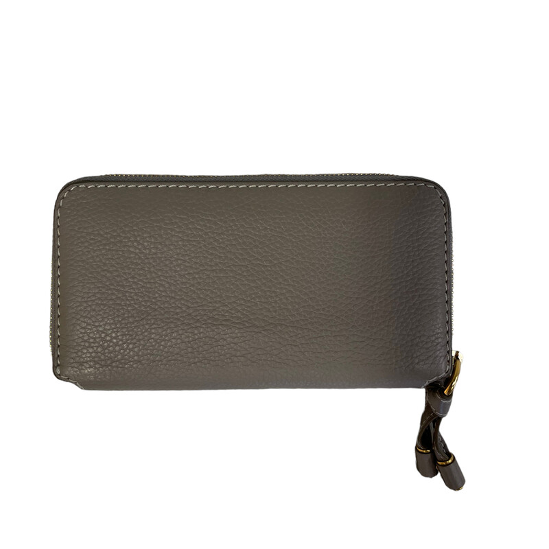 CHLOE Calfskin Long Zip Around Marcie Wallet in Cashmere Grey. This beautiful clutch wallet is crafted of lovely textured calfskin leather in grey with white and gray stitched detailing. The gold wrap-around zipper tassel opens to a beige leather interior with twelve card slots, two patch pockets, and a partition zipper compartment
Dimensions:
Base length: 7.50 in
Height: 4.50 in
Width: 1.00 in
