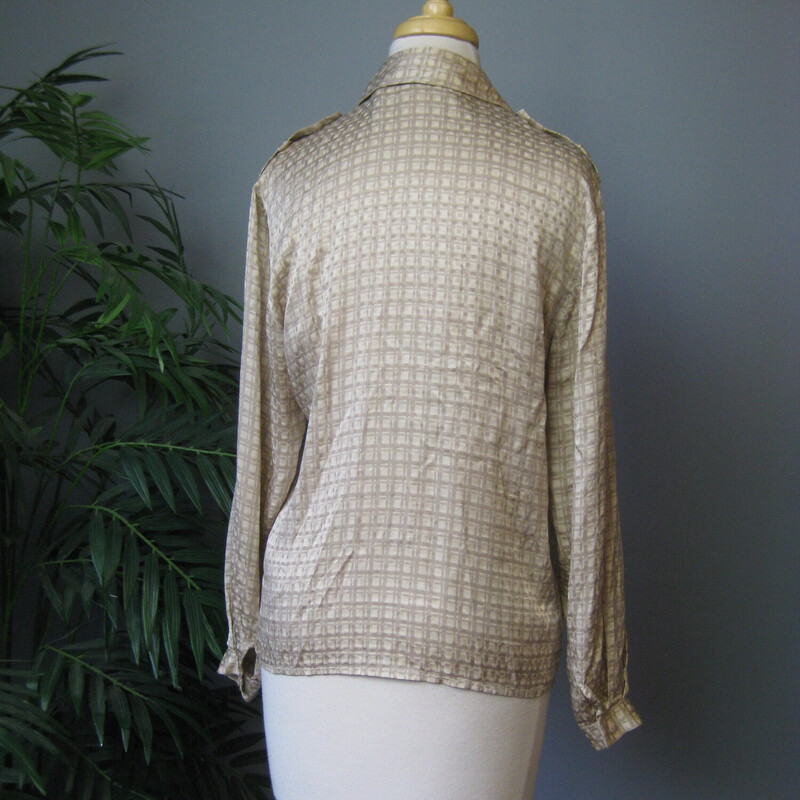 Beige abstract grid print silk blouse from Saks Fifth Avenue. Probably made in the mid 80s<br />
The brand name on this blouse has a fascinating history, look up Irving Spitalnick to learn more.<br />
<br />
The neat feature on this blouse are the epaulettes on the shoulders, otherwise its a simple mix and matchable high quality blouse.<br />
<br />
Marked size 4<br />
flat measurements:<br />
shoulder to shoulder: 16.5<br />
armpit to armpit: 19.5<br />
length: 24.25<br />
Underarm sleeve seam length: 17<br />
Width at hem:  19<br />
<br />
thanks for looking!<br />
#63949