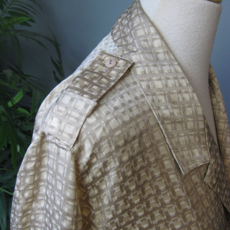 Beige abstract grid print silk blouse from Saks Fifth Avenue. Probably made in the mid 80s<br />
The brand name on this blouse has a fascinating history, look up Irving Spitalnick to learn more.<br />
<br />
The neat feature on this blouse are the epaulettes on the shoulders, otherwise its a simple mix and matchable high quality blouse.<br />
<br />
Marked size 4<br />
flat measurements:<br />
shoulder to shoulder: 16.5<br />
armpit to armpit: 19.5<br />
length: 24.25<br />
Underarm sleeve seam length: 17<br />
Width at hem:  19<br />
<br />
thanks for looking!<br />
#63949