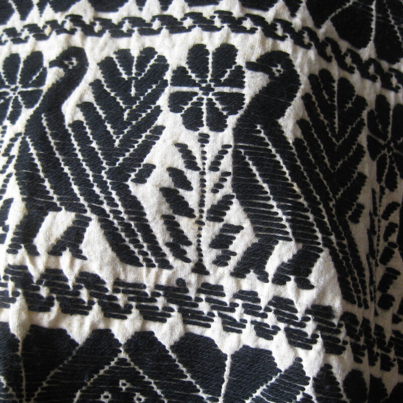 Vtg Cotton Poncho Embrd, Blk/crm, Size: None<br />
This is a gorgeous piece of textile.<br />
Formed into a simple short poncho.<br />
black and white<br />
it's got a cotton base and is embroidered with black wool.<br />
the design is mythical looking birds in bands alternating with a geometric pattern.<br />
<br />
Excellent vintage condition with some rust small diffuse rust spots throughout.<br />
width of neck opening: 15,<br />
length from neck opening to hem at the center: 14.5 not including the fringe, which is 2.5.<br />
<br />
Very wearable because it's short.  Looks amazing on and you can move and work and mingle without your arms behind restricted.<br />
<br />
Thanks for looking!<br />
#65046