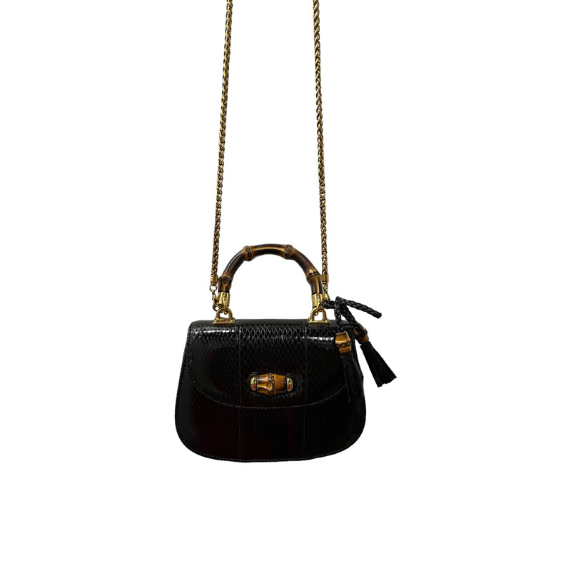 GUCCI Python Mini Bamboo Night Evening Bag in Black. Top handle bag is created of luxurious black python leather and has a looping sturdy bamboo top handle with light gold links, an optional chain shoulder strap, a bamboo knobbed tassel charm, and a faux bamboo turn lock for the frontal flap. This opens to a leather interior with zipper and patch pockets.

Dimesnsions:
Base length: 6.00
Height: 4.50
Width: 2.00
Drop: 2.00
Drop: 25.00