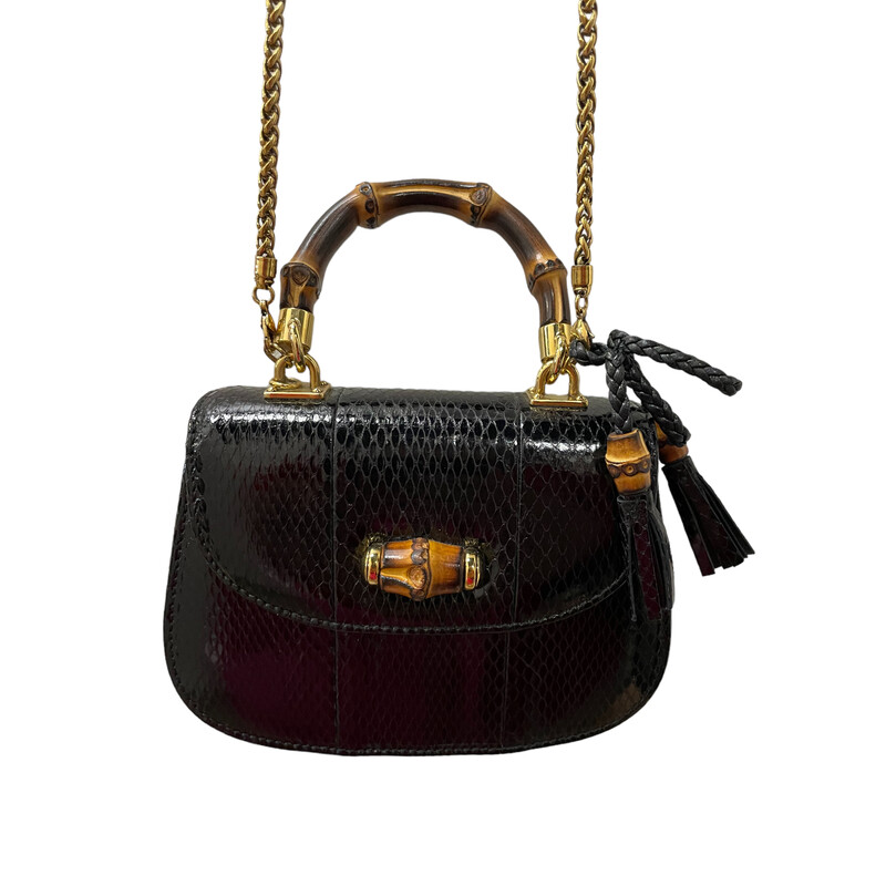 GUCCI Python Mini Bamboo Night Evening Bag in Black. Top handle bag is created of luxurious black python leather and has a looping sturdy bamboo top handle with light gold links, an optional chain shoulder strap, a bamboo knobbed tassel charm, and a faux bamboo turn lock for the frontal flap. This opens to a leather interior with zipper and patch pockets.

Dimesnsions:
Base length: 6.00
Height: 4.50
Width: 2.00
Drop: 2.00
Drop: 25.00