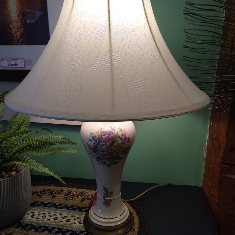 Victorian Style Lamp

Very pretty victorian style lamp with a floral design on white base.  Fabric shade with lace look and lace trim.

Size: 26 In Tall