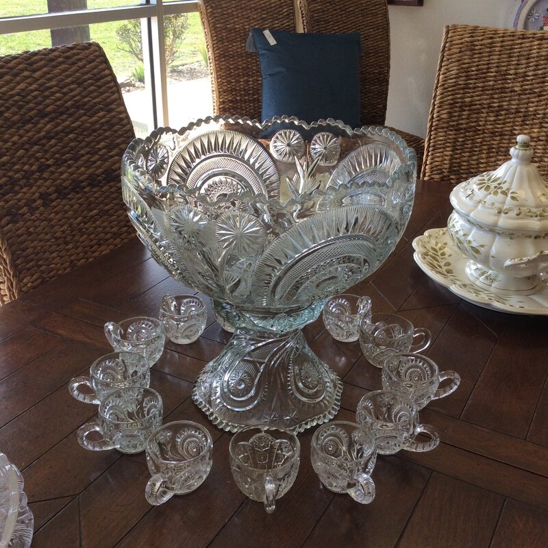 This is a gorgeous vintage Smith glass punchbowl set. The punchbowl comes with 13 cups and has a  pinwheel and stars etched pattern.