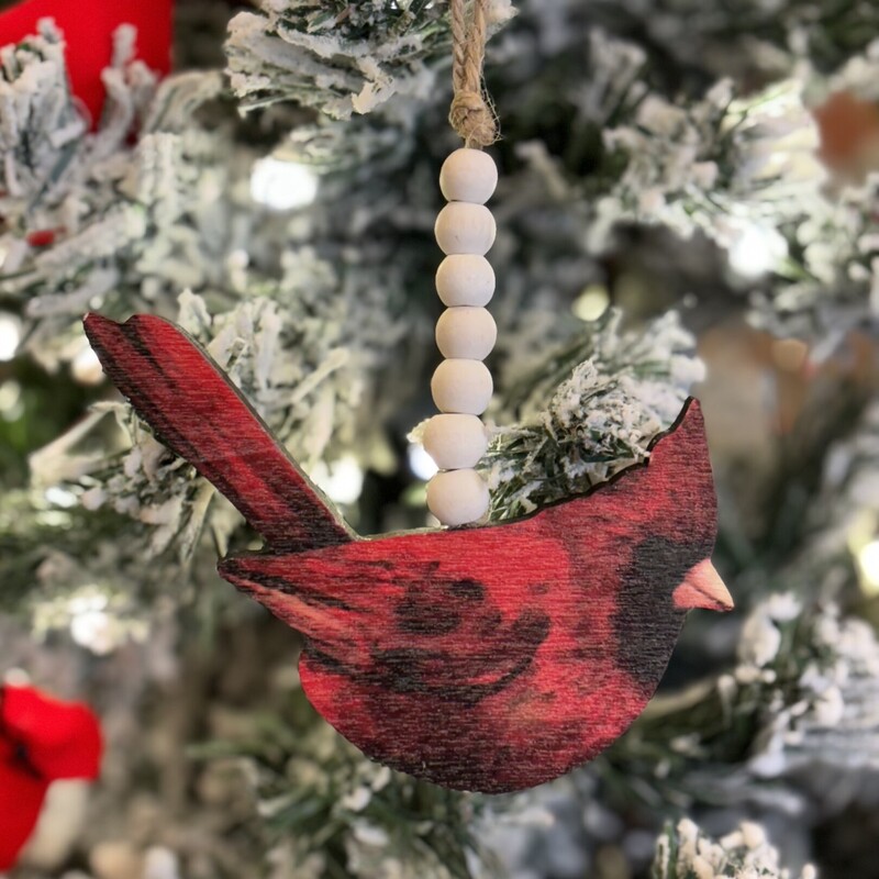 Wooden Cardinal and bead ornament measures 3 inches high and 4.25 inches wide.