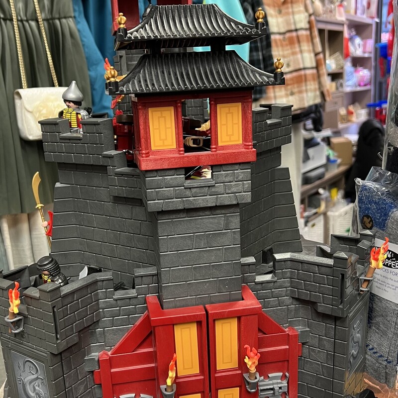 Playmobil Great Asian Castle 5479 & set 6038, Red/Grey/Black, Size: 5-12Y
Mini Figures Complete

Enemies beware! The Great Asian Castle is protected by a fierce fire-breathing dragon. When not flying around, the yellow dragon can guard the castle from the attachable landing platform. This fortified castle also includes plenty of features to help the soldiers defend it. The functioning portcullis keeps unwanted visitors out, while anyone who manages to sneak into the castle will be caught off by the hidden trapdoor. The trapdoor can also act as a secret getaway for the castle warriors. Keep enemies at bay using the functioning crossbow with flaming arrows. The rocky landscape also conceals a secret cave where kids can hide the sacred dragon fire, which lights up (batteries not included). Set also includes four figures, helmets, shields and additional battle gear, skeleton, torches, flags and other accessories.