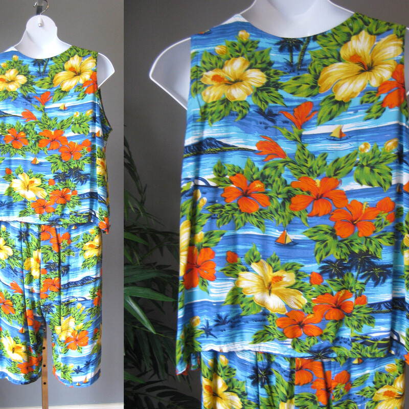 Cute summery rayon top and capris from the 80s.

It's a two piece outfit consisting of a relaxed v neck top and a pull-on pair of culottes with elastic waist, pockets and a drawstring to get just the right fit.
The print is a colorful tropical floral with some sequines sprinkled near the hems for a bit of sparkle.

Are you bold enough to wear these pieces together?
Or will you prefer to mix and match these as separates?
Both pieces are unlined
Made in India

Flat weave rayon, no stretch but the culottes have a wide elastic waistband.

Flat measurements:

Divided Skirt/Culottes:
waist: 19 stretches comfortably to 21
hip: up to 31
Rise: 16.75 (very high waisted and relaxed)
Inseam: 18

Shirt:
armpit to armpit: 26.5
length: 22.75
Width at hem when buttoned: 27.75
slits at the side seams: 3

both pieces excellent condition, no flaws
thanks for looking!
#2390