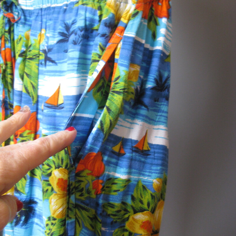 Cute summery rayon top and capris from the 80s.

It's a two piece outfit consisting of a relaxed v neck top and a pull-on pair of culottes with elastic waist, pockets and a drawstring to get just the right fit.
The print is a colorful tropical floral with some sequines sprinkled near the hems for a bit of sparkle.

Are you bold enough to wear these pieces together?
Or will you prefer to mix and match these as separates?
Both pieces are unlined
Made in India

Flat weave rayon, no stretch but the culottes have a wide elastic waistband.

Flat measurements:

Divided Skirt/Culottes:
waist: 19 stretches comfortably to 21
hip: up to 31
Rise: 16.75 (very high waisted and relaxed)
Inseam: 18

Shirt:
armpit to armpit: 26.5
length: 22.75
Width at hem when buttoned: 27.75
slits at the side seams: 3

both pieces excellent condition, no flaws
thanks for looking!
#2390