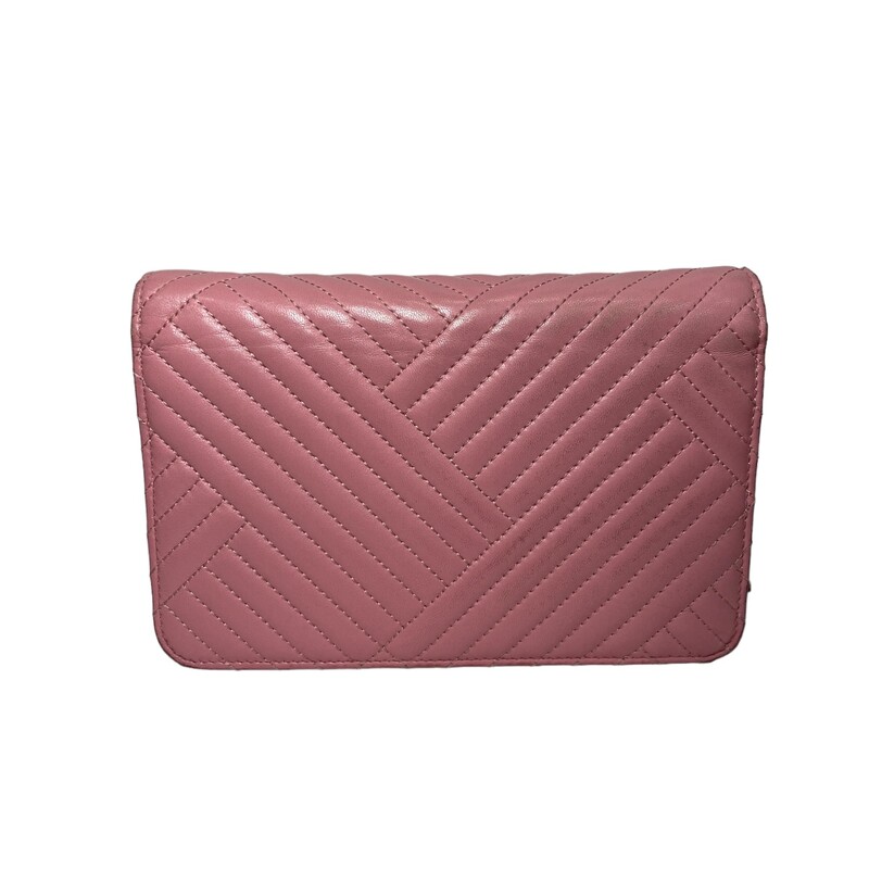 Chanel Chevron Crossing Pink WOC<br />
Chanel Crossbody Bag<br />
By Karl Lagerfeld<br />
Pink Lambskin<br />
Interlocking CC Logo, Quilted Pattern & Chain-Link Accent<br />
Silver-Tone Hardware<br />
Chain-Link Shoulder Strap<br />
Grosgrain Lining & Three Interior Pockets with Card Slots<br />
Snap Closure at Front<br />
<br />
Dimensions:<br />
Approx 4.9 x 7.5 x 1.4<br />
<br />
Code: 22701983<br />
Year:<br />
<br />
** Wear on the back upper corner on leather<br />
Corner wear on all corners