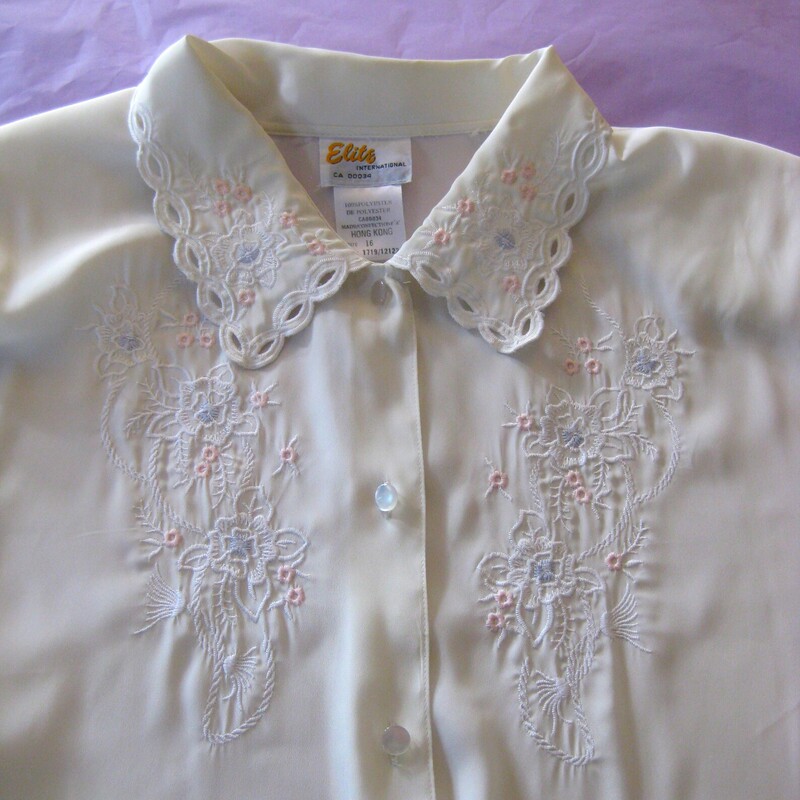 Vtg Elite Embd. Secy Blou, Ivory, Size:
Pretty vintage blouse in ivory by Elite from the 1980s with a bit of soft pink floral embroidery on the collar and the chest.  It closes with pearlized buttons down the front. buttons at the cuffs too
It's marked size 16 but probably better for a modern size 12-14
Made in Hong Kong
Excellent vintage condition. No flaws

Here are the flat measurements, please double where appropriate:
Shoulder to shoulder: 17
Armpit to Armpit: 22 1/2
Waist: 22 3/4
Width at Hem: 22
Length 25
Underarm sleeve seam length: 18

Thank you for looking
#67701