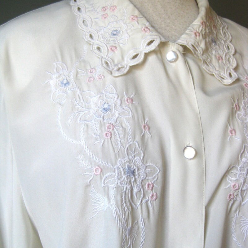 Vtg Elite Embd. Secy Blou, Ivory, Size:<br />
Pretty vintage blouse in ivory by Elite from the 1980s with a bit of soft pink floral embroidery on the collar and the chest.  It closes with pearlized buttons down the front. buttons at the cuffs too<br />
It's marked size 16 but probably better for a modern size 12-14<br />
Made in Hong Kong<br />
Excellent vintage condition. No flaws<br />
<br />
Here are the flat measurements, please double where appropriate:<br />
Shoulder to shoulder: 17<br />
Armpit to Armpit: 22 1/2<br />
Waist: 22 3/4<br />
Width at Hem: 22<br />
Length 25<br />
Underarm sleeve seam length: 18<br />
<br />
Thank you for looking<br />
#67701