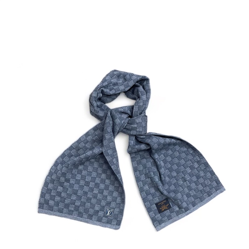 Louis Vuitton Blue Damier Scarf
Soft textures meet soft colors in the Petit Damier scarf. Knitted from pure wool using a high-precision technique, the details of the iconic Damier pattern are given a refined new treatment in subtle ink tones. The LV initials appear on a textile patch for a discreet logo finish.
Light blue
100% wool
Damier pattern
LV Initials on the patch at the bottom

Height Height: 12 inches
Base Length: 71 inches
Base Width: 0.1 inches
(Measurements are ap