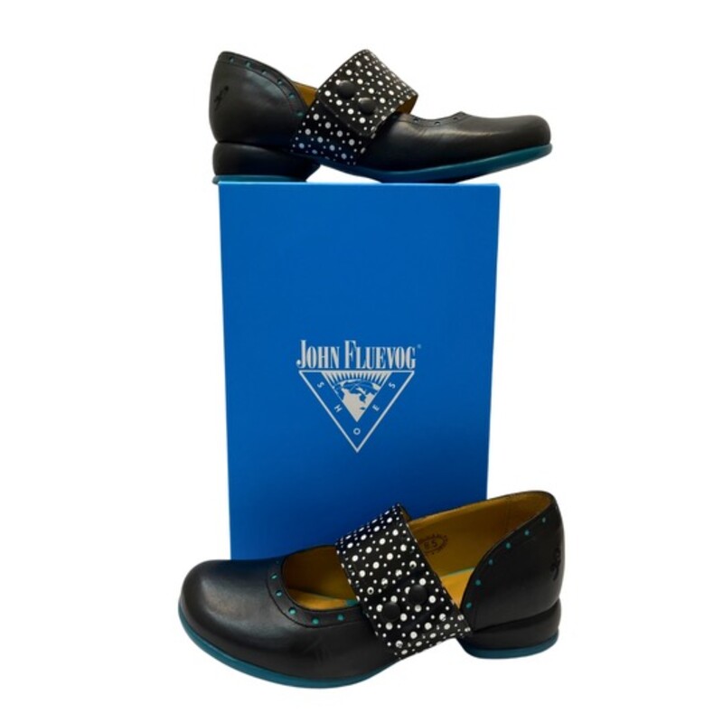 John Fluevog Fellowship Cleo Shoes<br />
<br />
Smooth, shiny Portuguese leather embellished with mall perforations along the strap and below the cuff, and cute buttons to keep the strap in place.<br />
Color: Black, White, and Turquoise Blue<br />
Size: 8.5