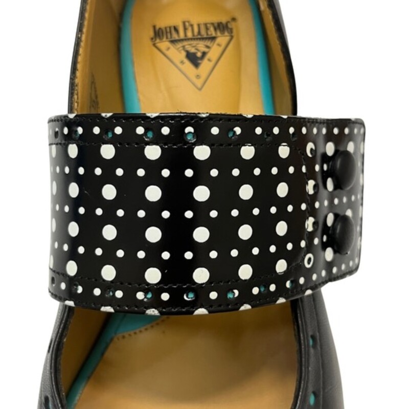 John Fluevog Fellowship Cleo Shoes

Smooth, shiny Portuguese leather embellished with mall perforations along the strap and below the cuff, and cute buttons to keep the strap in place.
Color: Black, White, and Turquoise Blue
Size: 8.5