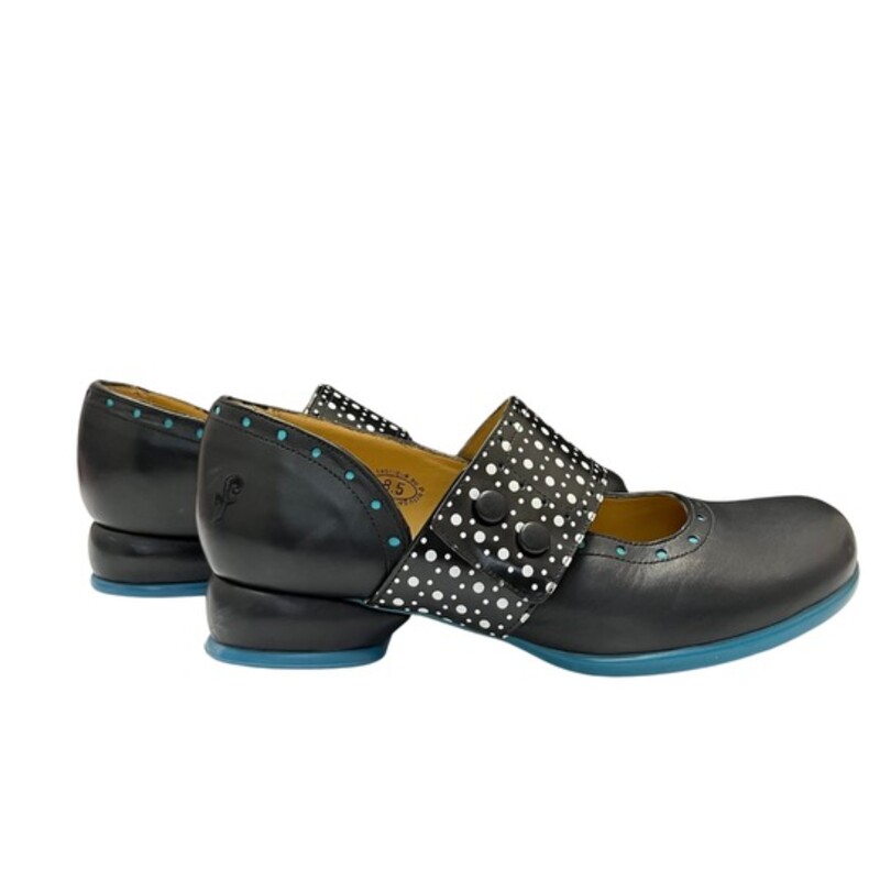 John Fluevog Fellowship Cleo Shoes

Smooth, shiny Portuguese leather embellished with mall perforations along the strap and below the cuff, and cute buttons to keep the strap in place.
Color: Black, White, and Turquoise Blue
Size: 8.5