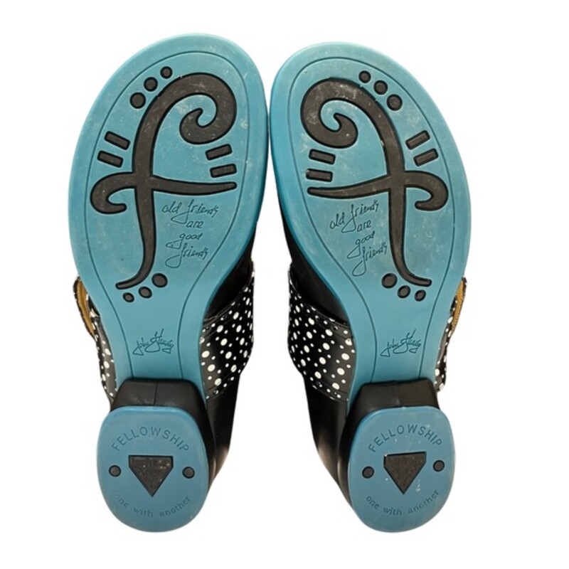 John Fluevog Fellowship Cleo Shoes<br />
<br />
Smooth, shiny Portuguese leather embellished with mall perforations along the strap and below the cuff, and cute buttons to keep the strap in place.<br />
Color: Black, White, and Turquoise Blue<br />
Size: 8.5