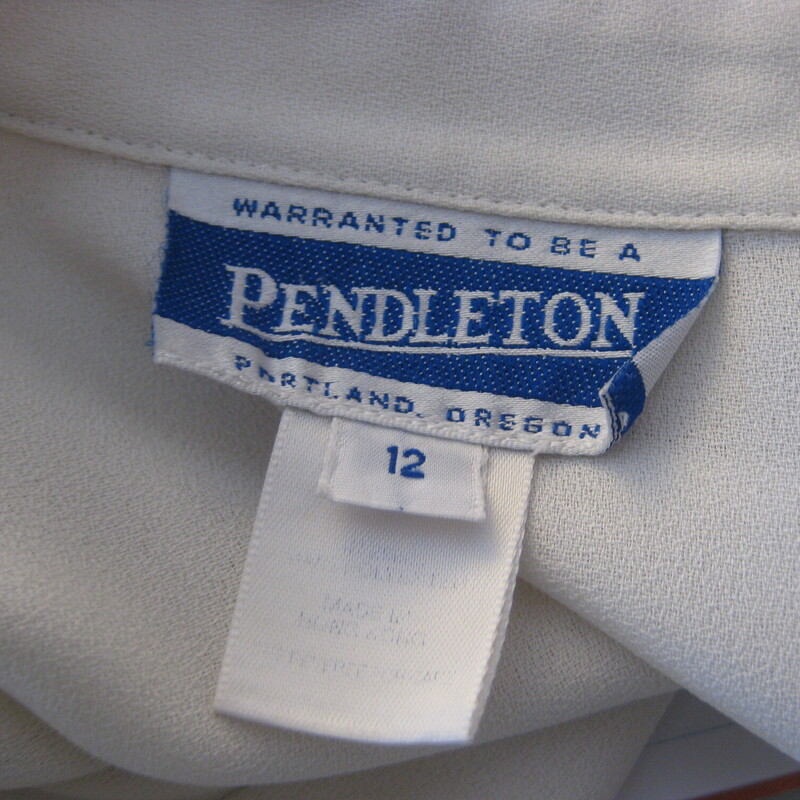 Vtg Pendleton, Ivory, Size: 12<br />
Vintage Pendleton Blouse in white polyester with a black ribbon threaded through the collar points and the cuffs.  Color is a grayish white<br />
marked size 12, should fit a modern size large.<br />
Flat measurements, please double where approrpriate:<br />
Shoulder to shoulder: 17.25<br />
Armpit to Armpit: 22<br />
Length: 26<br />
width at hem: 19 3/4<br />
Underarm sleeve seam length: 17.5<br />
<br />
Excellent condition!<br />
<br />
thank for looking!<br />
#52577