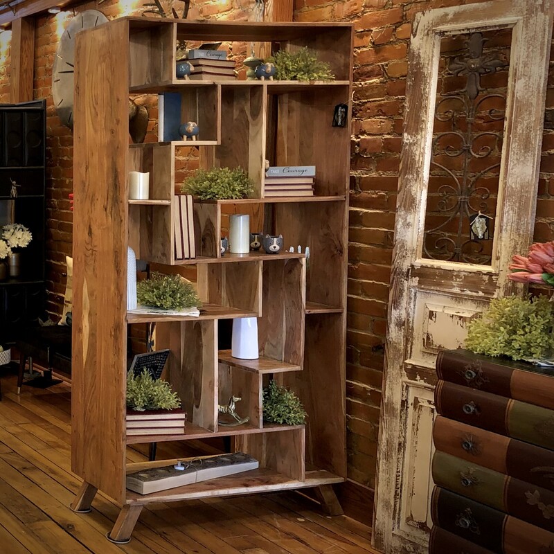 Acacia Shelving Unit
75 H x 39 L x 13 D
Imagine the rich, golden hues of acacia wood, each shelf boasting its own unique grain pattern like a map to undiscovered treasure. With its natural beauty and rustic charm, this shelving unit adds a touch of warmth and whimsy to any room, turning mundane storage into a safari of style.