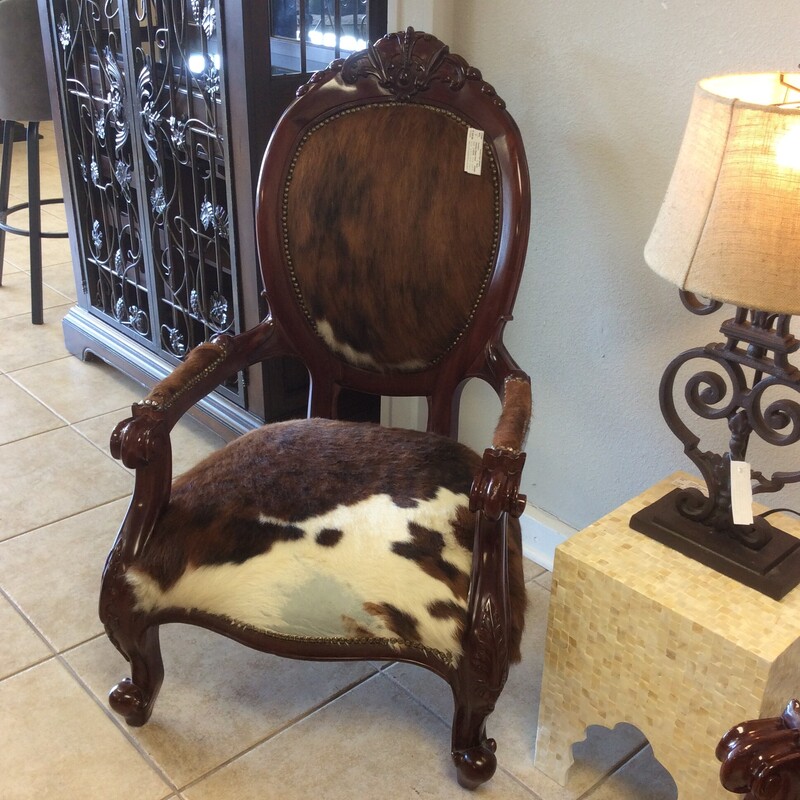 This is so cool! This traditionally designed slipper chair will remind you of the past, but this is a chair that beautfully represents the past and the present. Upholstered in cowhide with a big, bold nailhead trim. We have 2 of them priced separately.