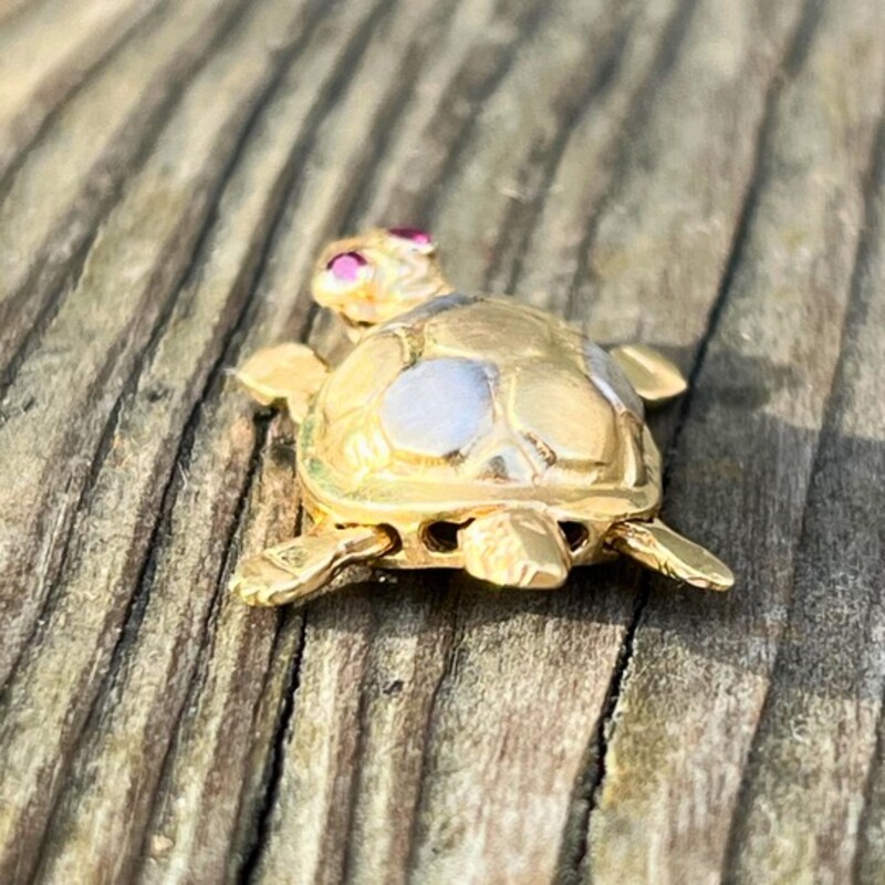 14K Tri Color Gold Turtle Pendant<br />
Featuring White, Yellow, and Rose Golds<br />
Two Real Ruby Eyes<br />
Moveable Limbs, Head, and Tail- This LittleTurtle Really Swims!<br />
Measures Around 1 inch Head to Tail