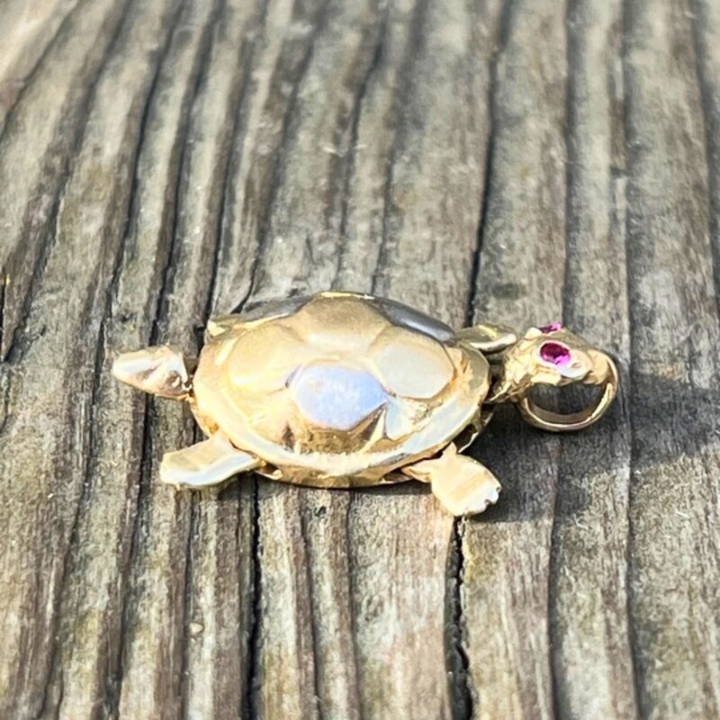 14K Tri Color Gold Turtle Pendant<br />
Featuring White, Yellow, and Rose Golds<br />
Two Real Ruby Eyes<br />
Moveable Limbs, Head, and Tail- This LittleTurtle Really Swims!<br />
Measures Around 1 inch Head to Tail