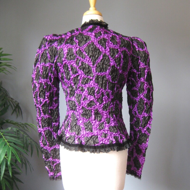 Vtg Farinae Lace Rouch, Purple, Size: Medium<br />
Fabulous statement evening jacket by Farinae Collections.<br />
It's made of puckery stretchy purple and black fabric with a subtle giraffe print.<br />
Black lace trim at the edges.<br />
classic 80s silhouette, huge at the shoulders, nipped at the waist.<br />
fully lined.<br />
Hook n eye closure<br />
Made in the USA<br />
<br />
Excellent condition. No flaws.  It may  have been part of a two piece ensemble.<br />
The lining comes to waist, not all the way to the hem and it has an elasticized bottom edge.<br />
<br />
interior flat measurements:<br />
shoulder to shoulder: 13.25<br />
armpit to armpit: 16.5 (the fabric is quite stretchy)<br />
Waist: 15<br />
underarm sleeve seam length: 22<br />
length: 24<br />
<br />
thanks for looking!<br />
#64977
