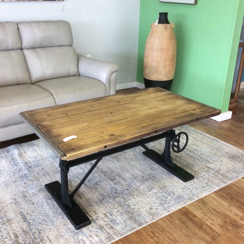 Super cool! This industrual-style coffee table from Pottery Barn features a black metal base and a wood plank-style table top. It also features a big, bold nailhead trim. Best of all, it's height adjustable. Come  take a look, it won't be here long!