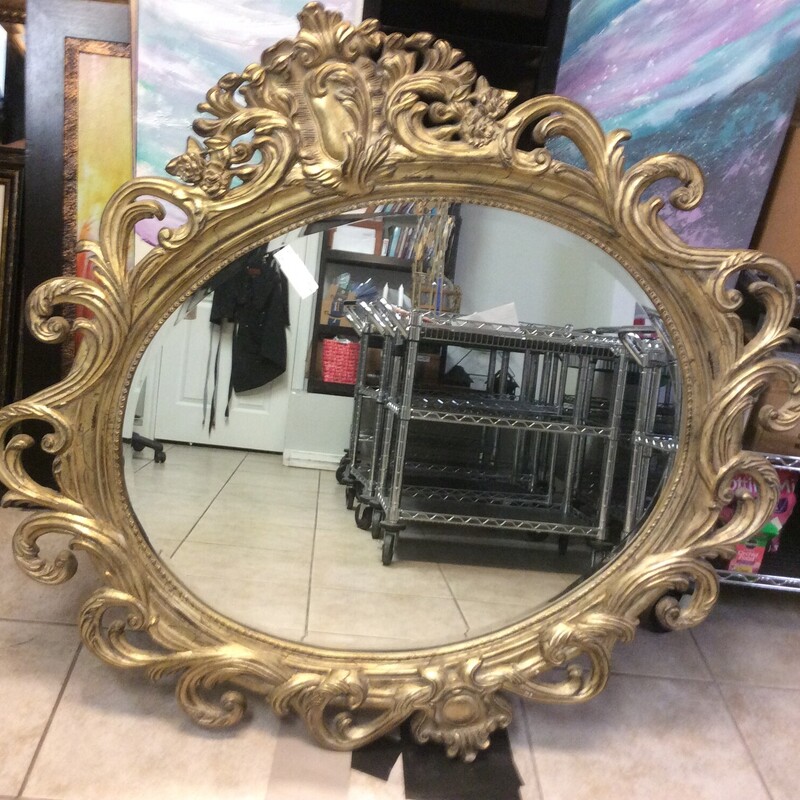Ornate gold framed mirror, heavy. Size: 50dia